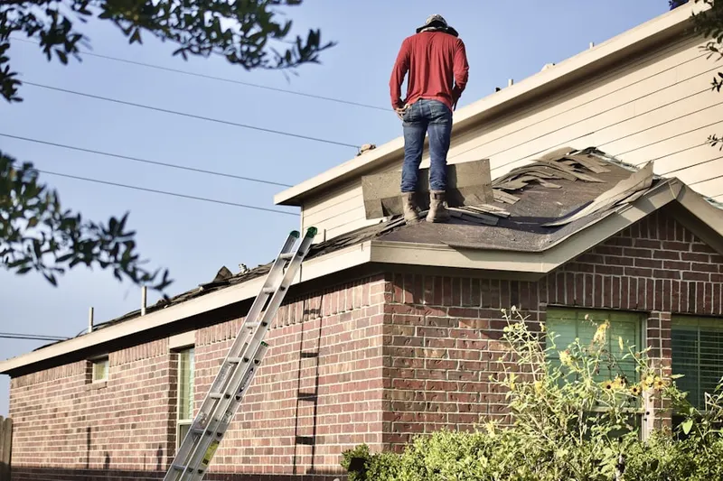 Professional roofer working on a residential roof in Deerfield Center